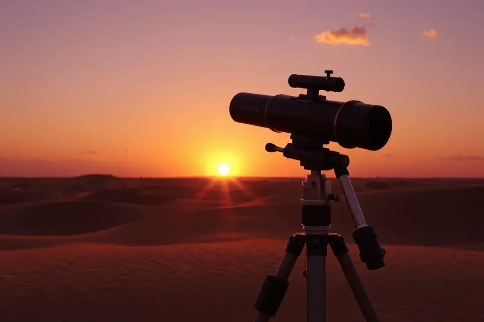 telescope silhouetted against sunset